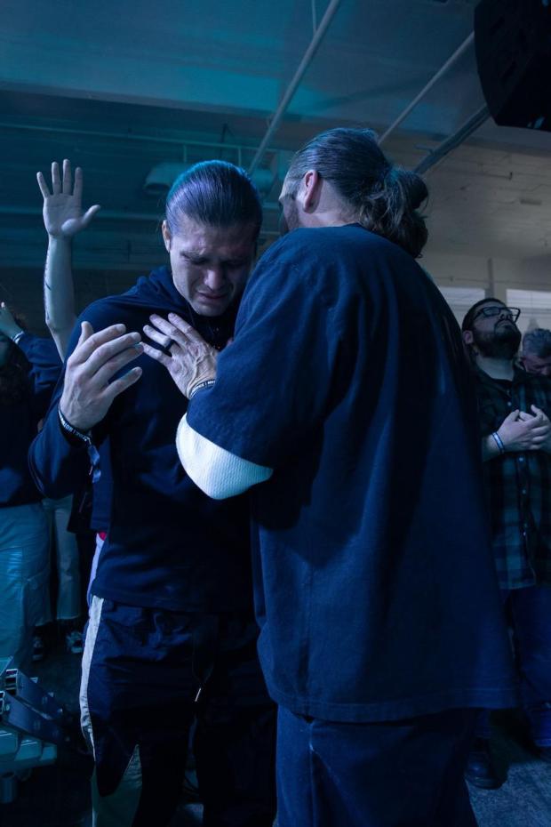 Fearless LA lead pastor Jeremy Johnson puts his hands on and prays with UFC featherweight Brian Ortega. (Photo by Manuel Aquino)