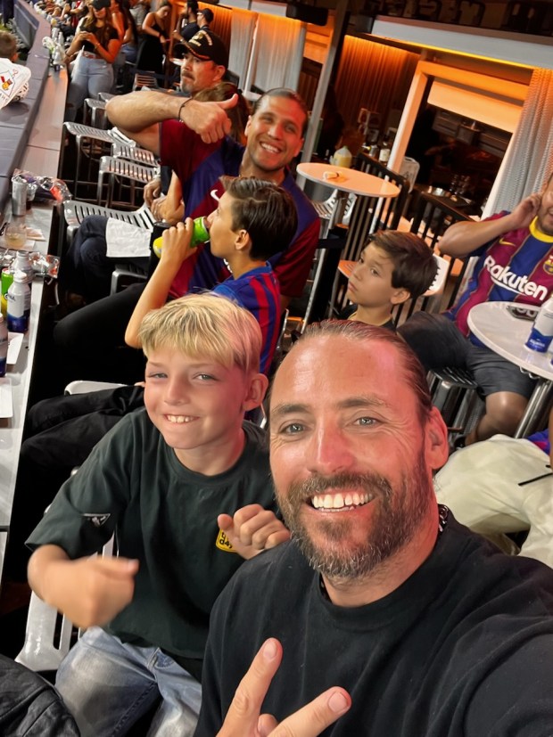 Fearless LA lead pastor Jeremy Johnson, front, and UFC featherweight Brian Ortega, rear, take in a soccer friendly between Barcelona FC and Arsenal with their sons July 26, 2023, at SoFi Stadium. (Photo courtesy of Jeremy Johnson)