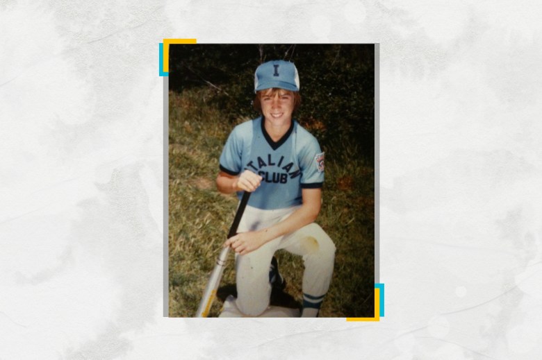 A young Gavin Newsom in a baseball uniform posing for a photo.