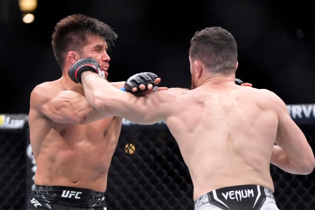 Merab Dvalishvili, right, connects with Henry Cejudo during their bantamweight bout at UFC 298 on Saturday, Feb. 17, 2024, at Honda Center. (AP Photo/Mark J. Terrill)