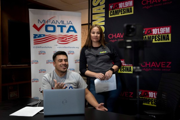 Staff members Michael Ruiz, left, and Marisol Moraga participate in a phone bank event at La Campesina, a Spanish-language radio network in Phoenix, Wednesday, March 20, 2024. A surge of misinformation is targeting Spanish-speaking voters with a high-stakes presidential election looming in the fall and candidates vying for support from the rapidly growing number of Latino voters. In one of the most important swing states, Arizona, La Campesina is countering that with a dedicated effort to provide Latino voters the facts about voting and how elections are run. (AP Photo/Serkan Gurbuz)