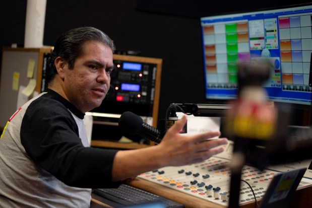 Radio host Tony "El Tigre" Arias speaks during a live broadcast at the Phoenix studio of La Campesina, a Spanish-language radio network, Thursday, March 21, 2024. A surge of misinformation is targeting Spanish-speaking voters with a high-stakes presidential election looming in the fall and candidates vying for support from the rapidly growing number of Latino voters. In one of the most important swing states, Arizona, La Campesina is countering that with a dedicated effort to provide Latino voters the facts about voting and how elections are run.. (AP Photo/Serkan Gurbuz)