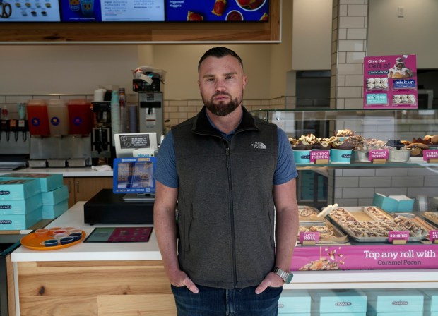 Alex Johnson, who owns 10 Auntie Anne's and Cinnabon stores in the San Francisco Bay area, stands in his store in Livermore, Calif., Thursday, March 28, 2024. He said his stores will have to raise prices to cover the increase in his employees' wages to $20 an hour. (AP Photo/Terry Chea)