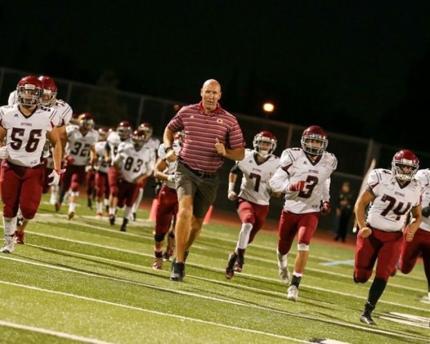 John Kusleika leads one of his Ontario High School football teams onto the field. Kusleika, 55, died March 9 after being diagnosed with cancer. (Courtesy of Gil Zendejas)
