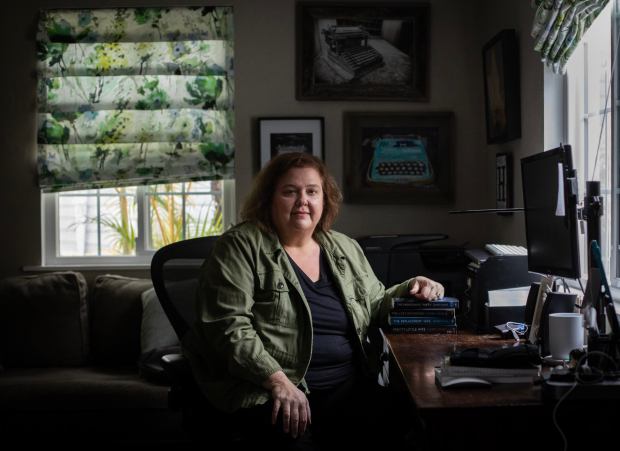 HelenKay Dimon, a novelist, poses for a portrait inside her home on Tuesday, Feb. 20, 2024 in San Diego, California. (Ana Ramirez / The San Diego Union-Tribune)
