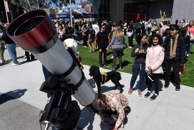 People look through a telescope at a partial solar eclipse during a viewing at Orange Coast College in Costa Mesa, CA on Monday, April 8, 2024. Southern California saw a partial eclipse with a little over 50% coverage. (Photo by Paul Bersebach, Orange County Register/SCNG)