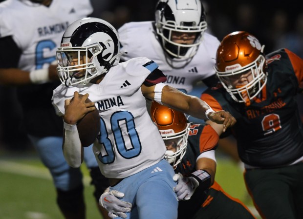 Ramona's Sincere Tolbert tries to escape from Riverside Poly's Israel Morales in the CIF Southern Section Division 11 football championship game at King HS stadium on Friday Nov. 24 2023. (Photo by Milka Soko, Contributing Photographer)