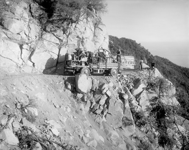 This custom-built truck was the first vehicle of its kind, specifically designed to haul heavy equipment from Pasadena, to the observatory construction site on Mount Wilson. The truck was a hybrid gasoline/electric vehicle with four electric motors, and four-wheel steering to accommodate the extreme conditions of the treacherous Mount Wilson Road. Mule teams were required to assist the truck through the soft, slippery sections. This photo was taken Aug. 1, 1907. (Photo from Mount Wilson Observatory photographs and audiovisual materials, The Huntington Library, San Marino)