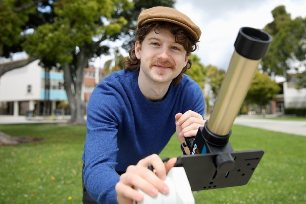 CSULB assistant professor Joel Zinn sets up the telescope he'll be using to view the upcoming solar eclipse, on Friday, Apr. 5, 2024, on the Cal State Long Beach campus. (Photo by Howard Freshman, Contributing Photographer)