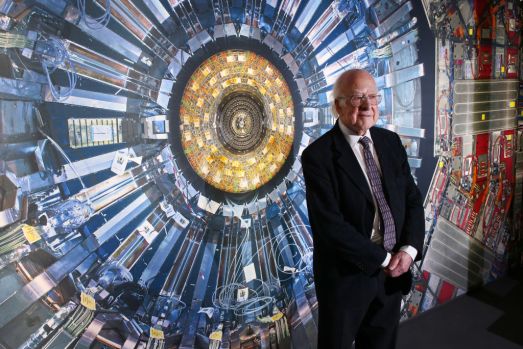 LONDON, ENGLAND – NOVEMBER 12:  Professor Peter Higgs stands in front of a photograph of the Large Hadron Collider at the  Science Museum’s ‘Collider’ exhibition on November 12, 2013 in London, England. At the exhibition, which opens to the public on November 13, 2013  visitors will see a theatre, video and sound art installation and artefacts from the Large Hadron Collider, providing a behind-the-scenes look at the CERN particle physics laboratory in Geneva. It touches on the discovery of the Higgs boson, or God particle, the realisation of scientist Peter Higgs theory.  (Photo by Peter Macdiarmid/Getty Images)
