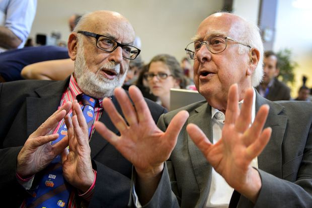 British physicist Peter Higgs (R) speaks with Belgium physicist Francois Englert at a press conference on July 4, 2012 at European Organization for Nuclear Research (CERN) offices in Meyrin near Geneva. After a quest spanning nearly half a century, physicists said on July 4 they had found a new sub-atomic particle consistent with the Higgs boson which is believed to confer mass. Rousing cheers and a standing ovation broke out at the CERN after scientists presented data in their long search for the mysterious particle. AFP PHOTO / FABRICE COFFRINI (Photo credit should read FABRICE COFFRINI/AFP/GettyImages)